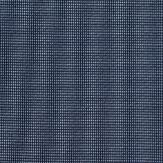 a close up view of a blue fabric textured with small squares and dots on it