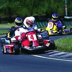 three go kart racers racing down the track