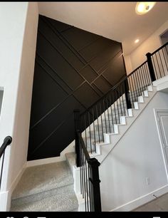 the stairs are painted black and white to match the walls in this room with carpeted flooring