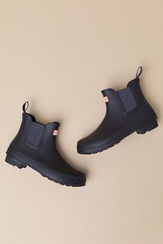 Romanticize rainy days with every step in the Hunter Original Navy Chelsea Rain Boots! These matte rubber rain boots feature a rounded upper that rises to an ankle-high shaft with elastic gussets at the instep and outstep. The slip-on design features a pull tab and a ribbed-textured detail at the back, all atop a sturdy low-block heel. Logo tag at the front. Available in whole sizes only. 0. 75" rubber heel. Lightly cushioned insole. Rubber sole has nonskid markings. Man Made Materials. Imported Rain Boots With Rubber Sole For Fall Season, Short Rain Boots, Chelsea Rain Boots, The Hunter, Low Block Heels, Logo Tag, Rubber Heels, Pull Tab, Rainy Days