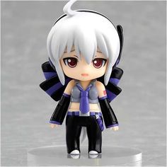 an anime character figurine is posed on a white surface with gray and black background