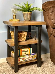 a wooden table with books and a basket on top next to a chair in a living room