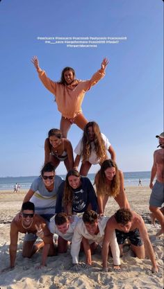 a group of people posing for a photo on the beach