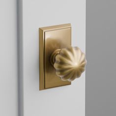 a light that is on the side of a white wall next to a door handle