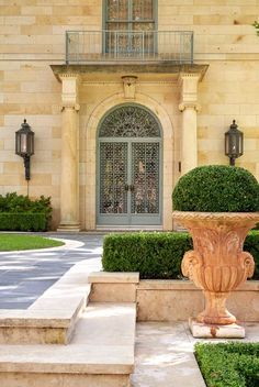 the front entrance to an elegant home with stone steps