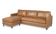 a tan leather sectional sofa sitting on top of a white floor