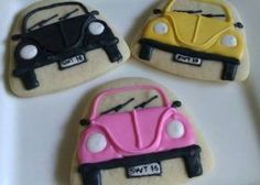 three decorated cookies with cars on them