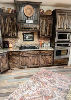 a kitchen with wooden cabinets and an area rug