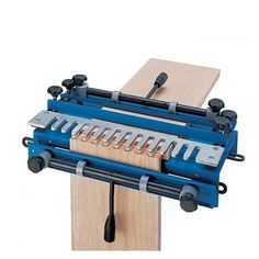 a bench vise with several tools attached to it