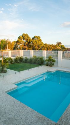 an empty swimming pool in the middle of a backyard