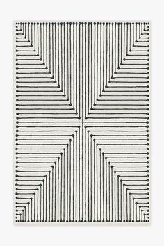 a white rug with lines on it and a square pattern in the middle, against a gray background