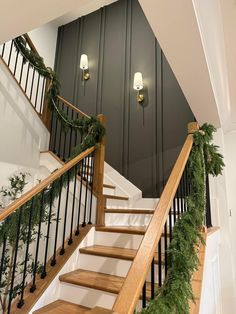 the stairs are decorated with christmas garland and lights on each handrail for an elegant touch