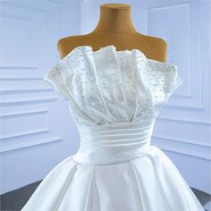 a white wedding dress on a mannequin