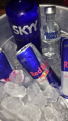 vodka bottles and ice cubes in a metal bowl