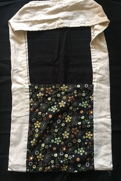 a black and white bag with flowers on it