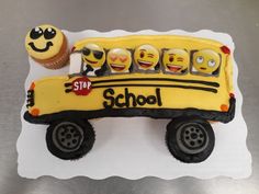 a cake shaped like a school bus with faces on it