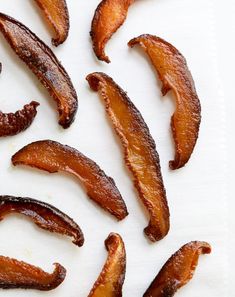 some bacon pieces are on a white surface and ready to be cut into wedges