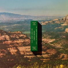 a green box sitting on the side of a mountain