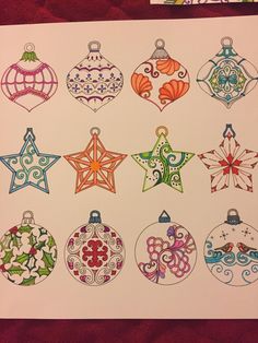 an image of christmas ornament designs drawn on white paper with colored pencils