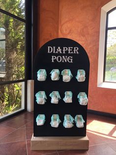 a display with diaper pong on it in a room next to a window