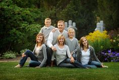 a family posing for a photo in the grass