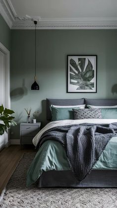 a large bed sitting in a bedroom next to a plant on top of a wooden floor