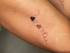 a couple of tattoos that are on the legs of someone's leg and one has a heart in it