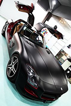 a black sports car parked in a showroom