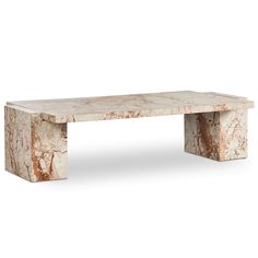 a white marble bench sitting on top of a wooden table