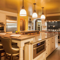 a large kitchen with an island, stove and oven in it's center area