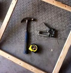 the tools are laying on the floor next to the pegs and screwdriver