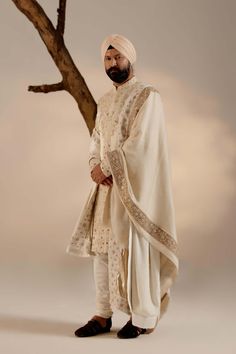 Editor's Note Featuring our work of art in our dirty ivory hand-embroidered sherwani which is intricately hand-embroidered with the essence of traditional chikankari motifs and embellishments p... Chikankari Motifs, Cream Sherwani, Embroidered Sherwani, Iranian Women, Royal Look, Indian Wedding Outfits, Churidar, Bridal Shop, Bridal Jewelry Sets