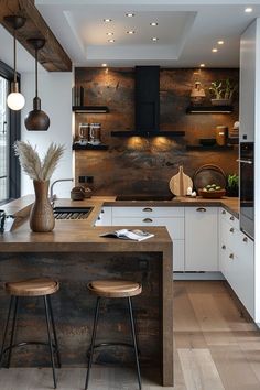 a kitchen with two stools next to an island