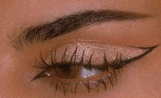 a woman's eye with long lashes and glitters on her eyeshade