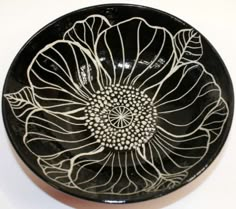 a black and white bowl with an intricate design on it