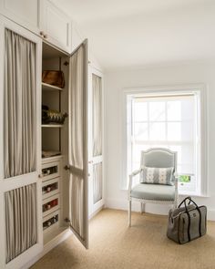 an open closet with a chair in it