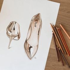 a drawing of a pair of shoes next to colored pencils