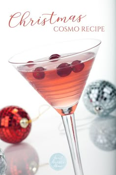 a christmas drink in a martini glass with cherries on the rim