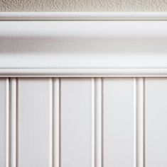 the corner of a room with white paneling