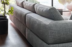 a living room filled with furniture next to a large window