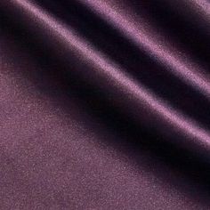 a close up view of a shiny purple fabric