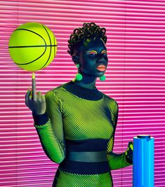 a woman holding a basketball in front of her face