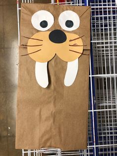 a brown paper bag with a cat face on it and some wire in the background