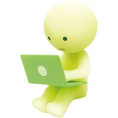 a small figure sitting on the ground with a laptop in his lap and looking at it