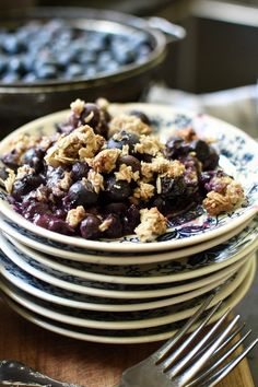 blueberries and crumbled oatmeal are stacked on top of each other