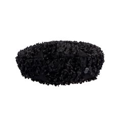 a black furry hat with skulls on the front and back side, sitting up against a white background