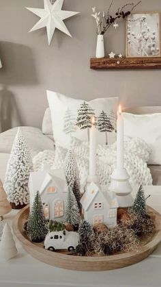 a tray with candles and christmas decorations on top of a bed in a room decorated for christmas