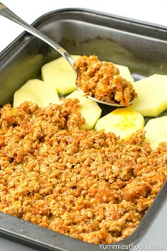 an image of food in a pan with spoons on the side to eat it