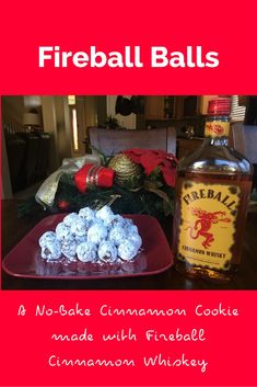 there is a bottle of fireball balls next to a plate of food on the table