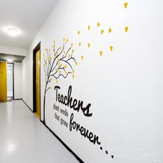 there is a white wall with yellow leaves on it and the words teachers are written in black